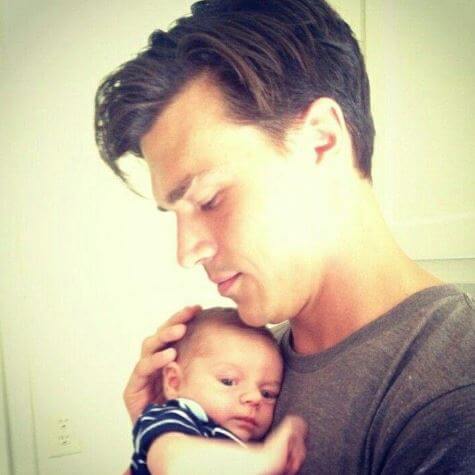 Finn Wittrock with a baby.